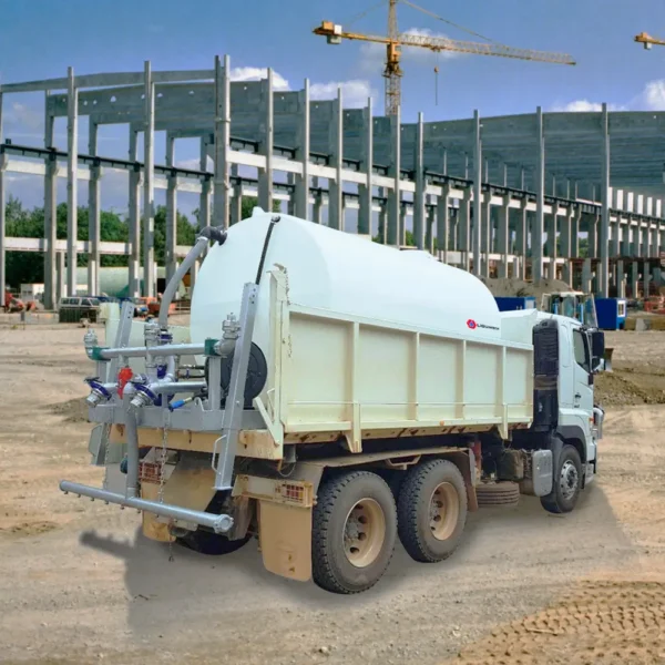Liquimech slip on water cart mounted in tipper truck with ladder and safety rails, ready for dust suppression on site.