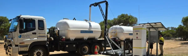 Overhead fill point allowing fast and controlled water transfer to service trucks in mining and construction environments
